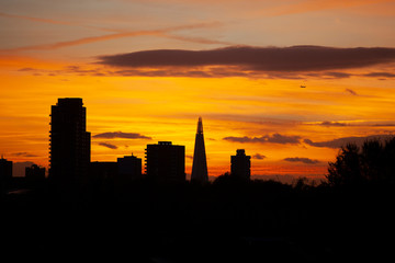 Beautiful sunset silhoutte over London skyline, with the iconic Shard building, london, uk