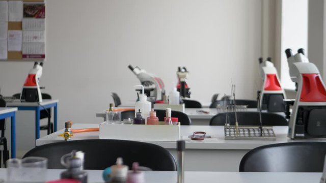 steady shoot of empty laboratory tables with microscopes and prepared equipment for laborants