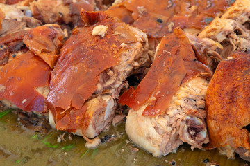 Roasted meat Lechon on banana leaf. Filipino eatery with grilled pork photo. Traditional cuisine of the Philippines.
