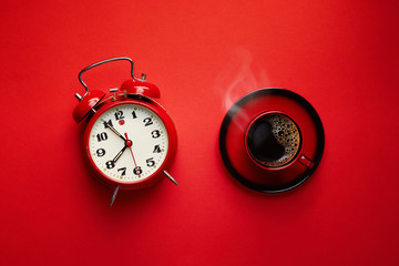 Retro alarm clock with cup of coffee.