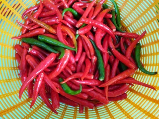 Top view of green and red pepper or chili on basket as a background for sale in the market at Thailand, abstract background, use for cooking