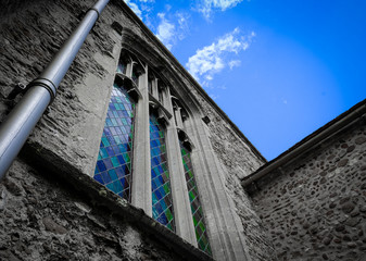 Power scene showing a stone built church tower and architectural window.
