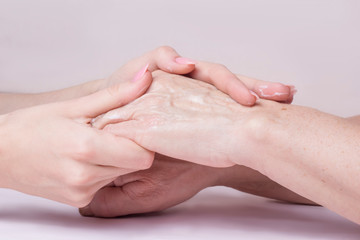 Fototapeta premium hands of a young woman doing massage on the hands of an elderly woman