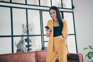 Portrait of her she nice-looking attractive charming cheerful lady using 5g app digital device launching start-up in modern style interior glass room flat house home indoors