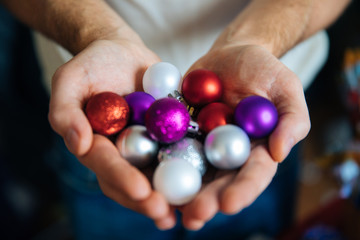 Awesome Christmas background, pink Christmas background with toys, Christmas tree balls in the palms of the palms, decorations for the highest events for the New Year and Christmas, a cozy home atmosp