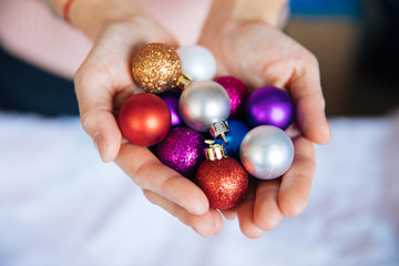 Awesome Christmas background, pink Christmas background with toys, Christmas tree balls in the palms of the palms, decorations for the highest events for the New Year and Christmas, a cozy home atmosp