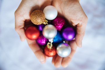 Awesome Christmas background, pink Christmas background with toys, Christmas tree balls in the palms of the palms, decorations for the highest events for the New Year and Christmas, a cozy home atmosp