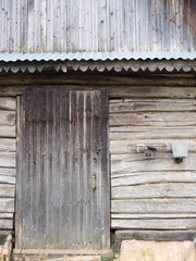 Door to an old aged barn in a village made of their wooden logs and planks