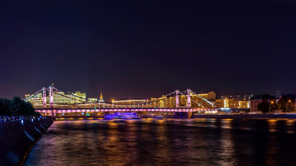 Fototapeta na wymiar Crimean bridge illuminated at night in Moscow