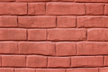 Texture of a brick wall coated with red paint