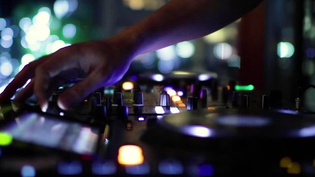 DJ's hand mixing music in the night party