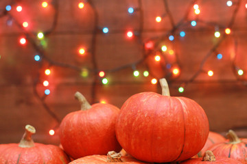 Pumpkins and colorful fairy lights. Welcome Autumn party invitation concept. Fall, Halloween, garlands, holiday