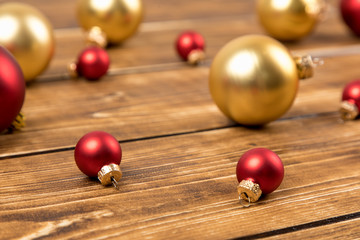 red and gold christmas balls on a wooden background