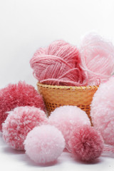 Fototapeta na wymiar pink pompom balls and yarns 