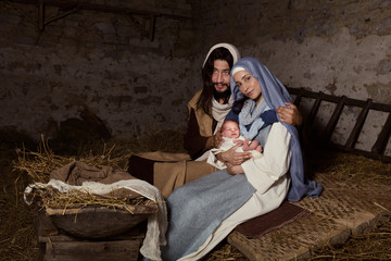 Live Christmas nativity scene in an old barn - Reenactment play with authentic costumes.