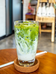 Iced green tea with milk in glass in coffee shop