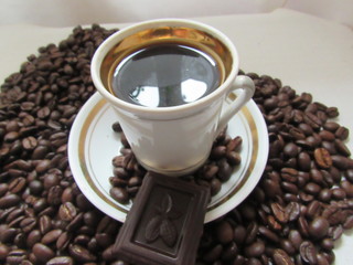 cup of coffee and beans on wooden background