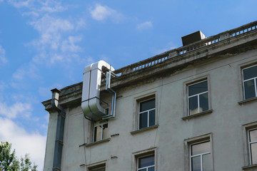 air conditioning exterior tubing mounted on an old building