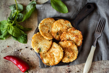 Vegetable fritters from cabbage on a wooden plate.