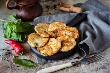Vegetable fritters from cabbage on a wooden plate.
