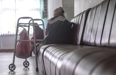 An old woman with a wheelchair on the couch. The foreground and background are specially lubricated.