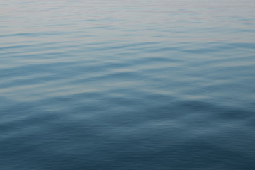 Abstract background of blue water, sea. Blurred background. Rippled water texture. Abstract background of the sea surface.
