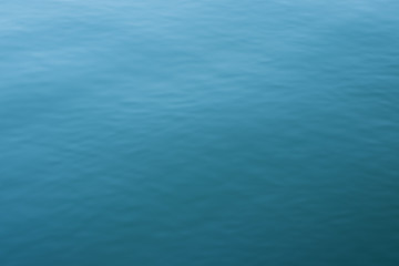 Abstract background of blue water, sea. Blurred background. Rippled water texture. Abstract background of the sea surface.