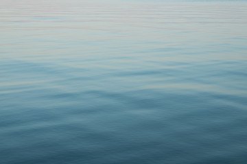 Abstract background of blue water, sea. Blurred background. Rippled water texture. Abstract background of the sea surface.