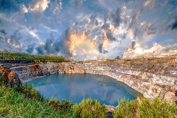 Fantastic view of Open Pit Mining on cloudy sky