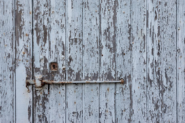 detail of an old wooden door seen in a village of Provence