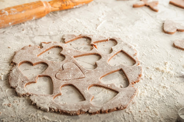 The texture of the dough closeup. Heart shaped gingerbread baking. Homemade cookies for Valentines Day and copy space. Keto baking.