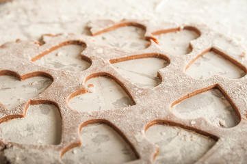 The texture of the dough closeup. Heart shaped gingerbread baking. Homemade cookies for Valentines Day and copy space. Keto baking.