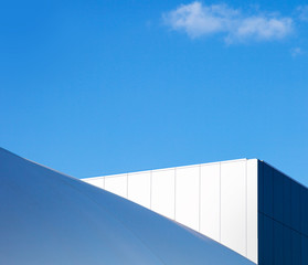 Modern fragment on a construction building, against blue sky
