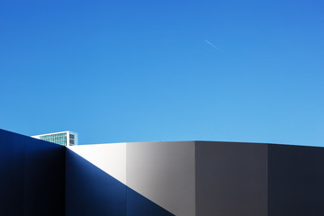 Modern fragment on a construction building, against blue sky