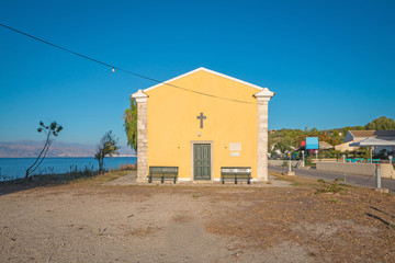 An old yellow church on the beach of the Island of Corfu, Greece