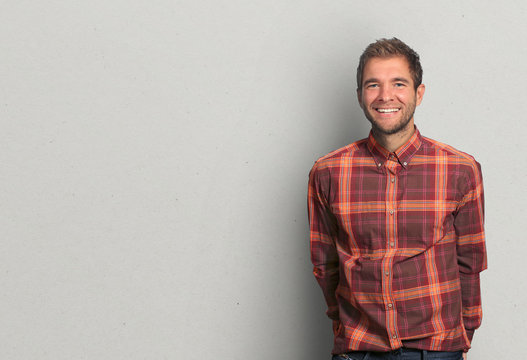 Young man in denim shirt is smiling