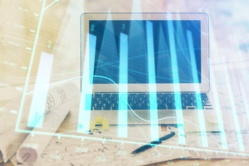 Forex Chart hologram on table with computer background. Multi exposure. Concept of financial...