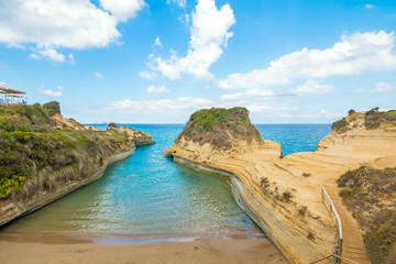 Colorful spring view of famous Channel Of Love (Canal d'Amour) beach. Bright morning seascape of Ionian Sea. Amazing outdoor scene of Corfu Island, Greece, Europe. Beauty of nature concept background