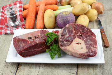 vegetables and raw meat for pot on fire on a wooden table