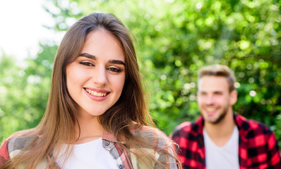Fototapeta premium happy day. girl in selective focus with man in park. couple in love. family weekend. romantic date. happy valentines day. summer camping in forest. first meet of couple outdoor. Relationship