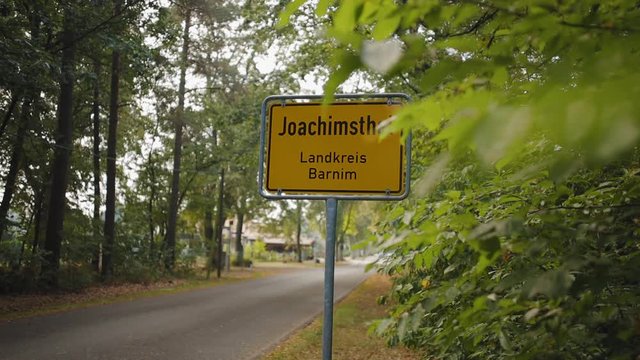 Slow motion lateral shot revealing Joachimsthal town traffic sign