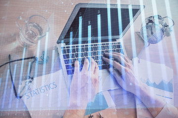 Multi exposure of forex graph with man working on computer on background. Concept of market analysis.