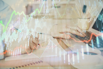 Multi exposure of stock market graph with man working on laptop on background. Concept of financial analysis.