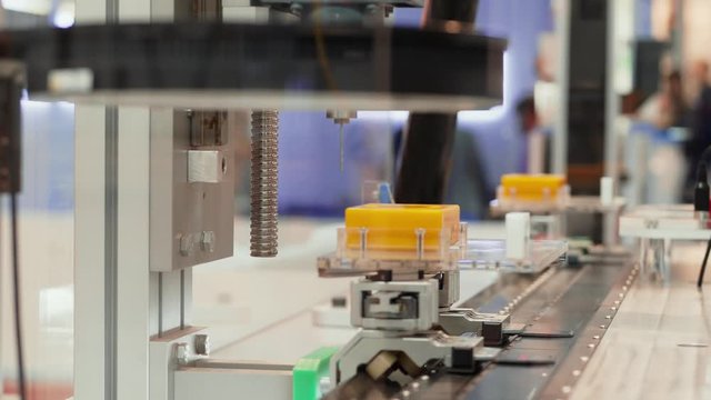 Automated control system scanning details on high speed conveyor belt, machining part by drilling, 3 shots. Moving items on conveyor under scanner of automatic test set. Computer-aided quality system