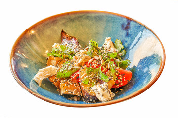 Salad with fried eggplant and various vegetables, sprinkled with seeds