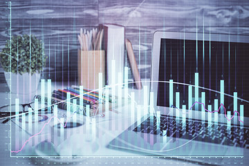 Stock market chart hologram drawn on personal computer background. Multi exposure. Concept of investment.