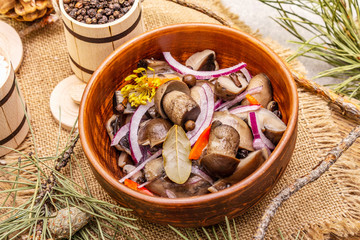 Pickled (fermented) mushrooms. Traditional New Year (Christmas) snack. Festive table cutlery setting