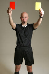 bald football referee on gray background. soccer referee raised both cards up. football referee in...