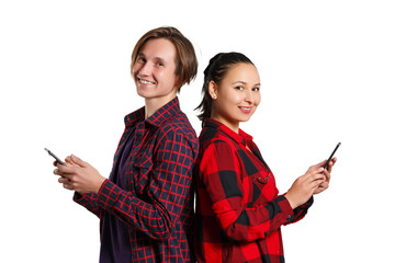 the guy and the girl are standing back to back and holding a smartphone isolated on white background