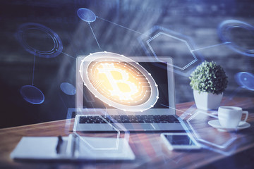 Multi exposure of blockchain theme hologram and table with computer background. Concept of bitcoin...